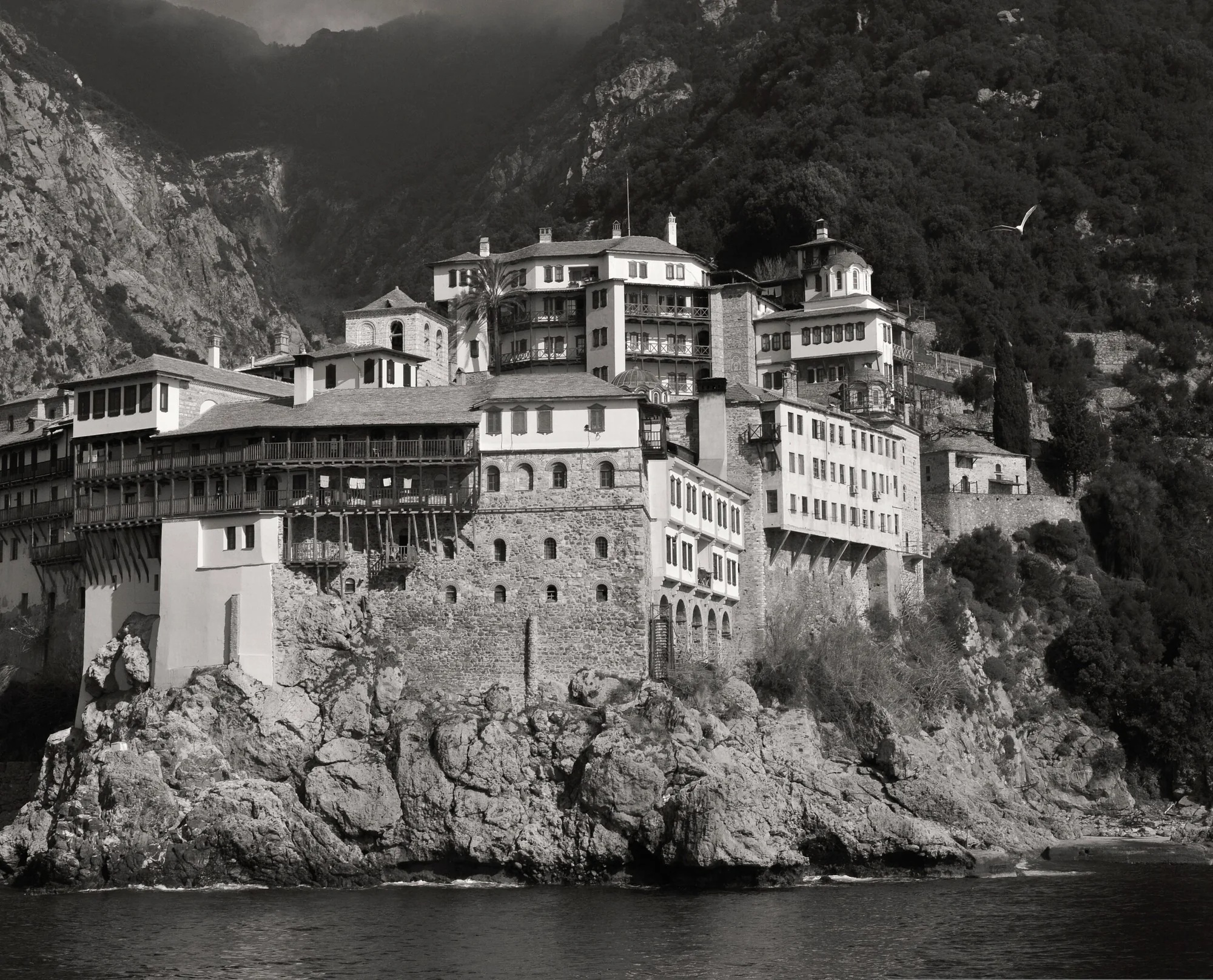 Historic monastery rising directly above the rocky western coast